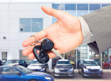 Hands with car keys. Dealer and client.